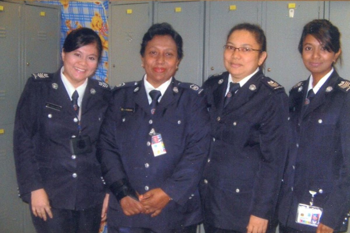 Four female officers standing together and smiling at the camera