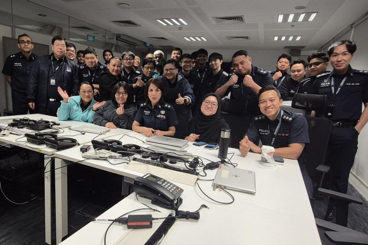A large group of police officers in an office room